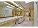 Large bathroom with a double vanity, bathtub, and wallpapered walls at 29903 Baywood Ln, Wesley Chapel, FL 33543