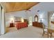 Large bedroom with ensuite bathroom, wood plank ceilings and neutral carpet at 29903 Baywood Ln, Wesley Chapel, FL 33543