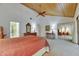 Spacious bedroom featuring wood plank ceiling, neutral carpet, and mirrored closet at 29903 Baywood Ln, Wesley Chapel, FL 33543