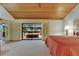 Bedroom with wood plank ceiling, neutral carpet, and access to the outdoor spa at 29903 Baywood Ln, Wesley Chapel, FL 33543