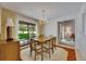 The dining area boasts natural light, a chandelier, and a view of the backyard at 29903 Baywood Ln, Wesley Chapel, FL 33543