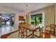 Bright dining room with chandelier, natural light, and views of the landscaped backyard at 29903 Baywood Ln, Wesley Chapel, FL 33543