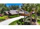 Stunning single-story home featuring mature landscaping, long driveway, and attached two car garage at 29903 Baywood Ln, Wesley Chapel, FL 33543