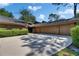 Charming single-story home featuring an attached two-car garage and mature landscaping at 29903 Baywood Ln, Wesley Chapel, FL 33543