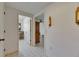 Inviting hallway with tile flooring, neutral walls, and doorways leading to other rooms at 29903 Baywood Ln, Wesley Chapel, FL 33543