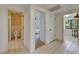 Hallway showing access to bathroom, bedroom, and laundry area with tile flooring throughout at 29903 Baywood Ln, Wesley Chapel, FL 33543