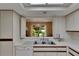 Bright kitchen with modern appliances, white countertops, and a view of the dining area at 29903 Baywood Ln, Wesley Chapel, FL 33543