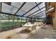 Enclosed lanai offering a great view of the yard with ample seating for relaxing and dining at 29903 Baywood Ln, Wesley Chapel, FL 33543