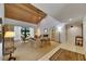 Bright living room featuring wood plank ceiling, fireplace, neutral carpet, and access to outdoor patio at 29903 Baywood Ln, Wesley Chapel, FL 33543