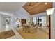 Spacious living room featuring a wood plank ceiling, neutral carpet, and access to the screened in patio at 29903 Baywood Ln, Wesley Chapel, FL 33543