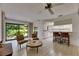Spacious living room with tile flooring and views of the backyard and kitchen at 29903 Baywood Ln, Wesley Chapel, FL 33543