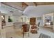 Bright living room with high wood plank ceilings, neutral carpet and access to an outdoor space at 29903 Baywood Ln, Wesley Chapel, FL 33543