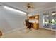 Bright office featuring a built-in desk, ample lighting, and a door to the outside at 29903 Baywood Ln, Wesley Chapel, FL 33543
