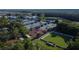 Aerial view of tennis courts and a lawn bowling area in a lush, landscaped community at 29903 Baywood Ln, Wesley Chapel, FL 33543