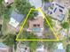 Aerial view showcasing property lines of a home with a pool in a treed residential neighborhood at 30 Pinetree Ct, Palm Harbor, FL 34683
