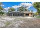 A home's rear exterior featuring a screened-in pool and spacious patio, enhancing outdoor living at 30 Pinetree Ct, Palm Harbor, FL 34683