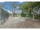 Large backyard with plenty of space, mature trees, and a screened-in pool area at 30 Pinetree Ct, Palm Harbor, FL 34683