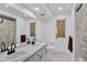 Bright bathroom featuring a double sink vanity, with a shower and neutral color scheme at 30 Pinetree Ct, Palm Harbor, FL 34683