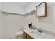 Neutral bathroom featuring light wood accents, white walls, and a single vanity at 30 Pinetree Ct, Palm Harbor, FL 34683