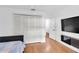 Neutral bedroom featuring hardwood floors, a large closet, and a television at 30 Pinetree Ct, Palm Harbor, FL 34683