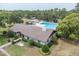 Aerial view of community clubhouse and pool area, with well-maintained landscaping and amenities at 30 Pinetree Ct, Palm Harbor, FL 34683