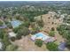 Aerial view of community pool and tennis courts, offering recreational amenities for residents at 30 Pinetree Ct, Palm Harbor, FL 34683
