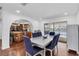 Bright dining area connected to the kitchen, featuring a modern table and view of the pool at 30 Pinetree Ct, Palm Harbor, FL 34683