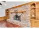 Close up of a brick fireplace with a decorative mantel and built-in shelves at 30 Pinetree Ct, Palm Harbor, FL 34683