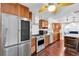 Bright kitchen showcasing stainless steel appliances, wooden cabinets, and hardwood floors at 30 Pinetree Ct, Palm Harbor, FL 34683