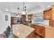 Bright kitchen featuring granite countertops, wood cabinets, stainless appliances, and hardwood floors at 30 Pinetree Ct, Palm Harbor, FL 34683