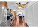 Bright kitchen featuring stainless steel appliances, wood cabinets, an island, and hardwood floors at 30 Pinetree Ct, Palm Harbor, FL 34683