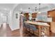 Open kitchen featuring a breakfast bar, granite countertops, and modern stainless-steel appliances at 30 Pinetree Ct, Palm Harbor, FL 34683