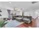 Spacious living room featuring hardwood floors, large sectional sofa, and ample natural light at 30 Pinetree Ct, Palm Harbor, FL 34683