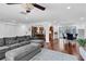 Open-concept living room flowing into dining area and kitchen, with hardwood floors and modern furniture at 30 Pinetree Ct, Palm Harbor, FL 34683