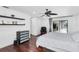 Bright main bedroom featuring hardwood floors, shelving, and sliding glass doors to the outdoor pool at 30 Pinetree Ct, Palm Harbor, FL 34683