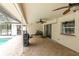 Large covered patio with brick flooring, multiple ceiling fans, and access to the pool at 30 Pinetree Ct, Palm Harbor, FL 34683