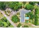Aerial view of estate showing the unique roof line, pool, motor court and lush landscaping at 3440 Crenshaw Lake Rd, Lutz, FL 33548