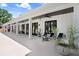 A long back porch features multiple seating areas and provides outdoor living space at 3440 Crenshaw Lake Rd, Lutz, FL 33548