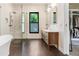 Bathroom featuring double vanities, a modern shower, and a soaking tub, enhanced by natural light at 3440 Crenshaw Lake Rd, Lutz, FL 33548