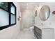 A modern bathroom features marble tile, a sleek vanity, and a glass-enclosed shower at 3440 Crenshaw Lake Rd, Lutz, FL 33548