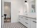 Stylish bathroom boasts dual sinks, hexagon tile flooring, and modern fixtures at 3440 Crenshaw Lake Rd, Lutz, FL 33548