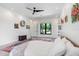 A bedroom featuring white walls, neutral decor, a modern ceiling fan, and a large window at 3440 Crenshaw Lake Rd, Lutz, FL 33548