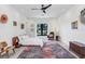 A bright bedroom has modern decor, a large rug, and natural light from the window at 3440 Crenshaw Lake Rd, Lutz, FL 33548