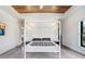 Spacious bedroom with concrete floors, wood ceilings, and minimalist decor at 3440 Crenshaw Lake Rd, Lutz, FL 33548