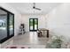 A spacious bonus room features a dining table, black-framed windows, and modern decor at 3440 Crenshaw Lake Rd, Lutz, FL 33548