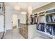 A spacious walk-in closet with custom shelving, a center island, and modern lighting fixtures at 3440 Crenshaw Lake Rd, Lutz, FL 33548