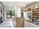 An organized walk-in closet with open shelving and cabinets, illuminated by decorative pendant lighting at 3440 Crenshaw Lake Rd, Lutz, FL 33548