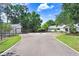 Circular driveway leading to the home and additional buildings, surrounded by well-maintained landscaping at 3440 Crenshaw Lake Rd, Lutz, FL 33548