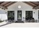 Inviting front porch with stylish seating and a welcoming entrance at 3440 Crenshaw Lake Rd, Lutz, FL 33548