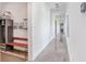 Hallway features polished concrete floors, modern lighting, and custom mud room at 3440 Crenshaw Lake Rd, Lutz, FL 33548